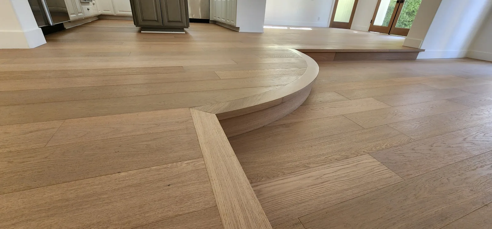Detail of a curved platform edge in white oak