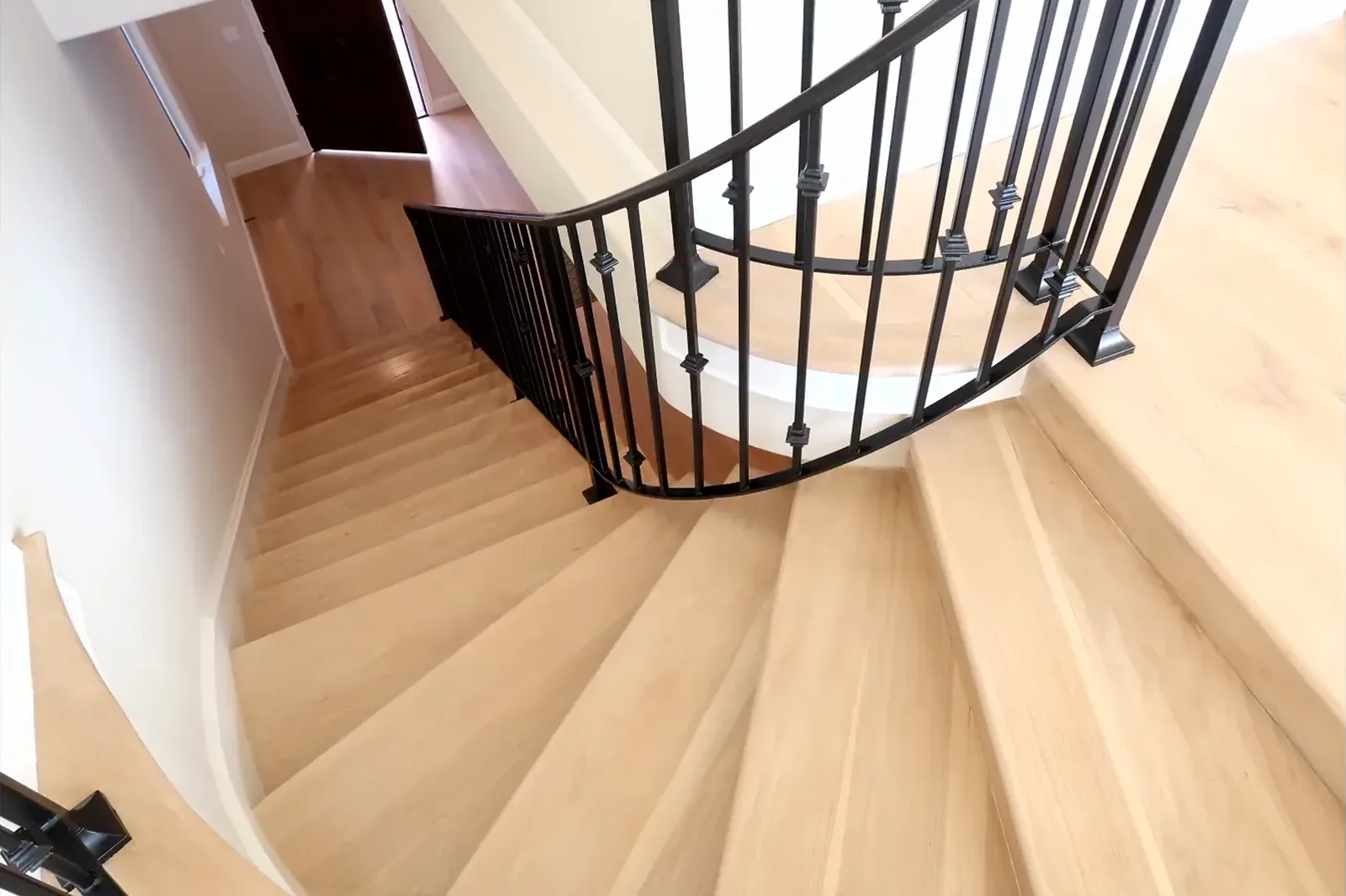 Detail of curved staircase treads and railing from below