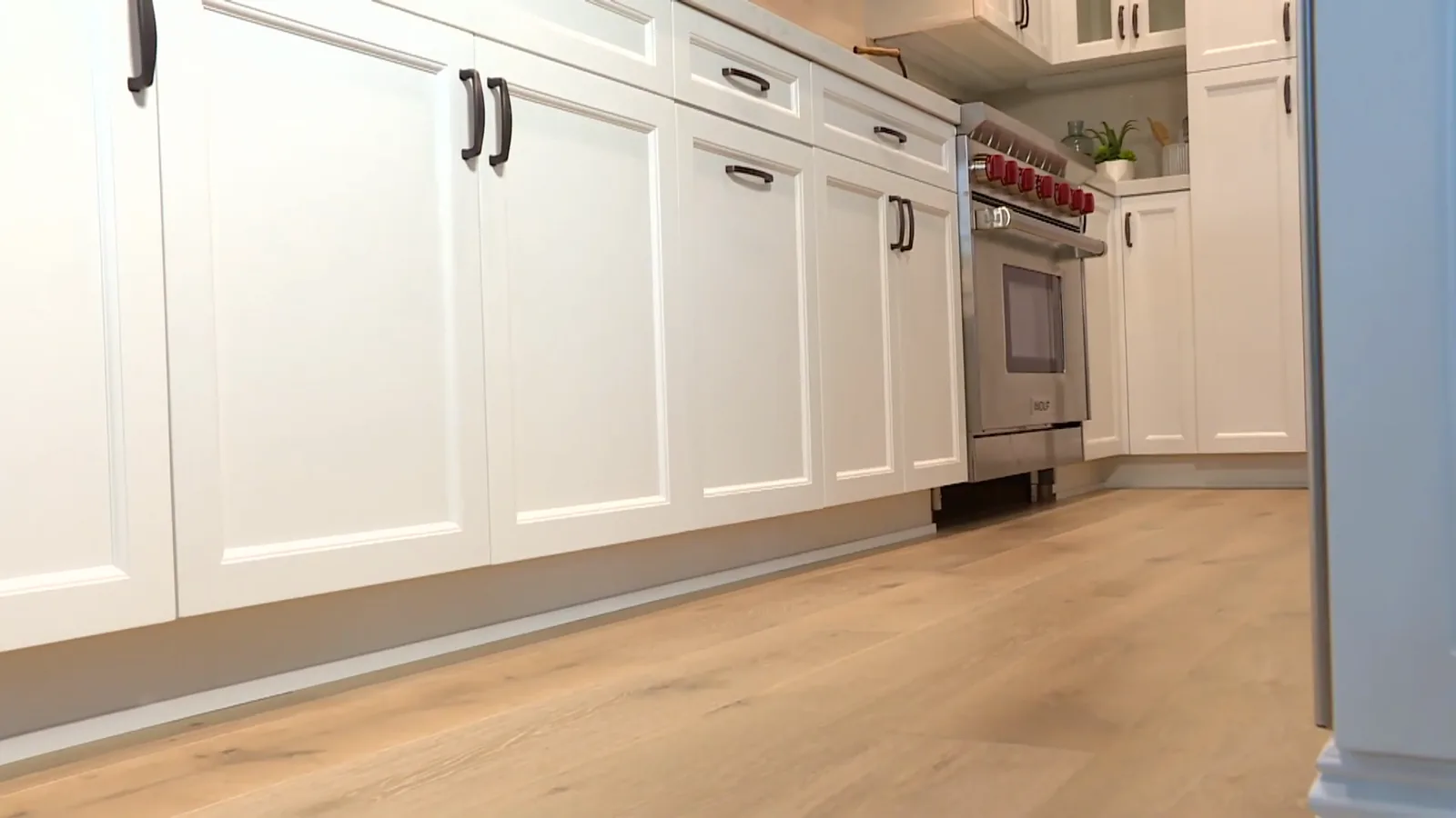 Light oak floors around a kitchen island