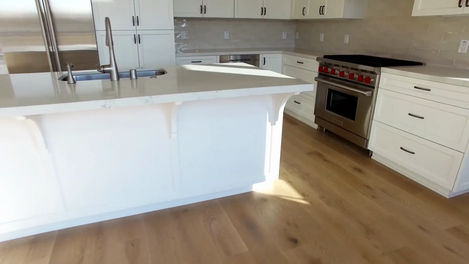 Wide-plank oak through a kitchen