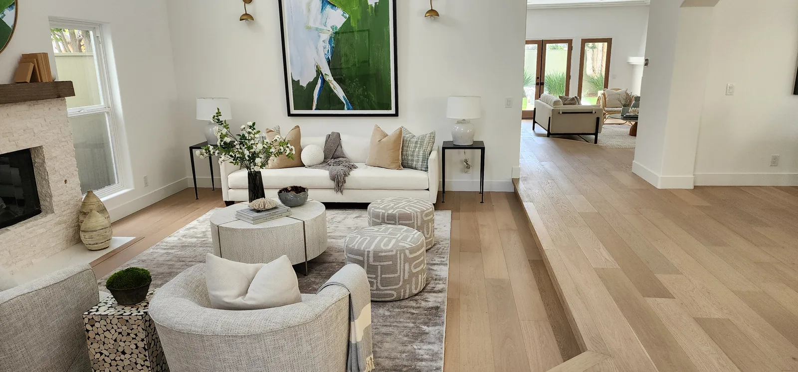 Finished living room with light oak flooring throughout