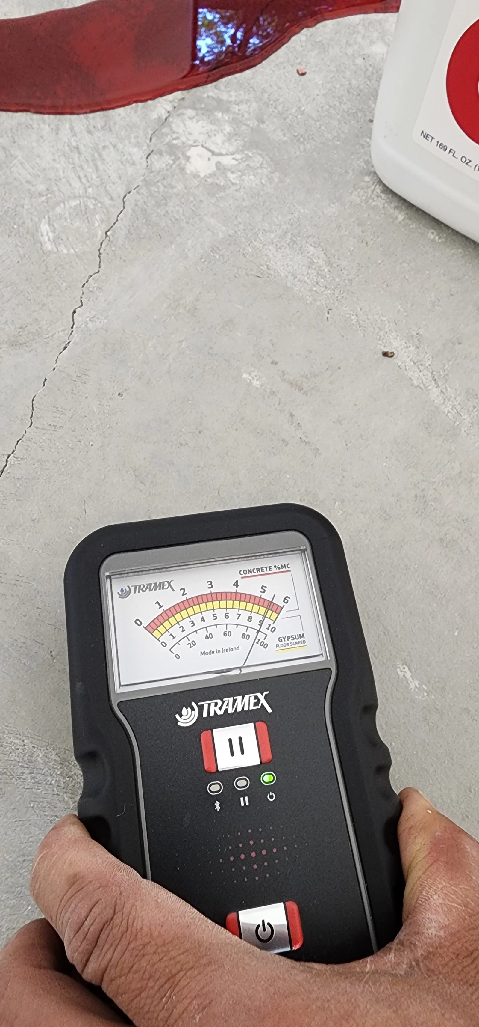 Moisture meter reading on a concrete slab before installation
