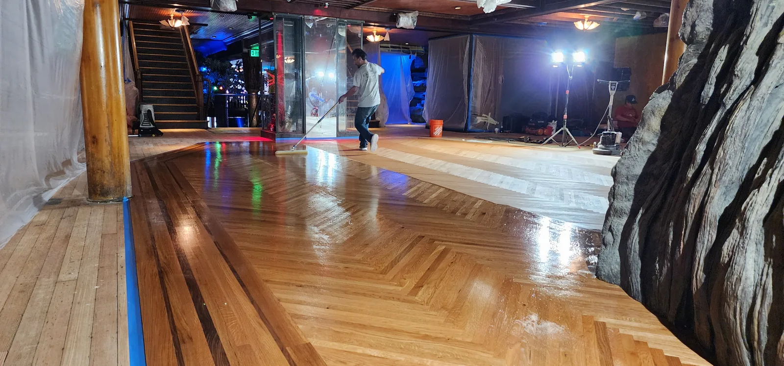 Herringbone parquet being refinished in a large venue